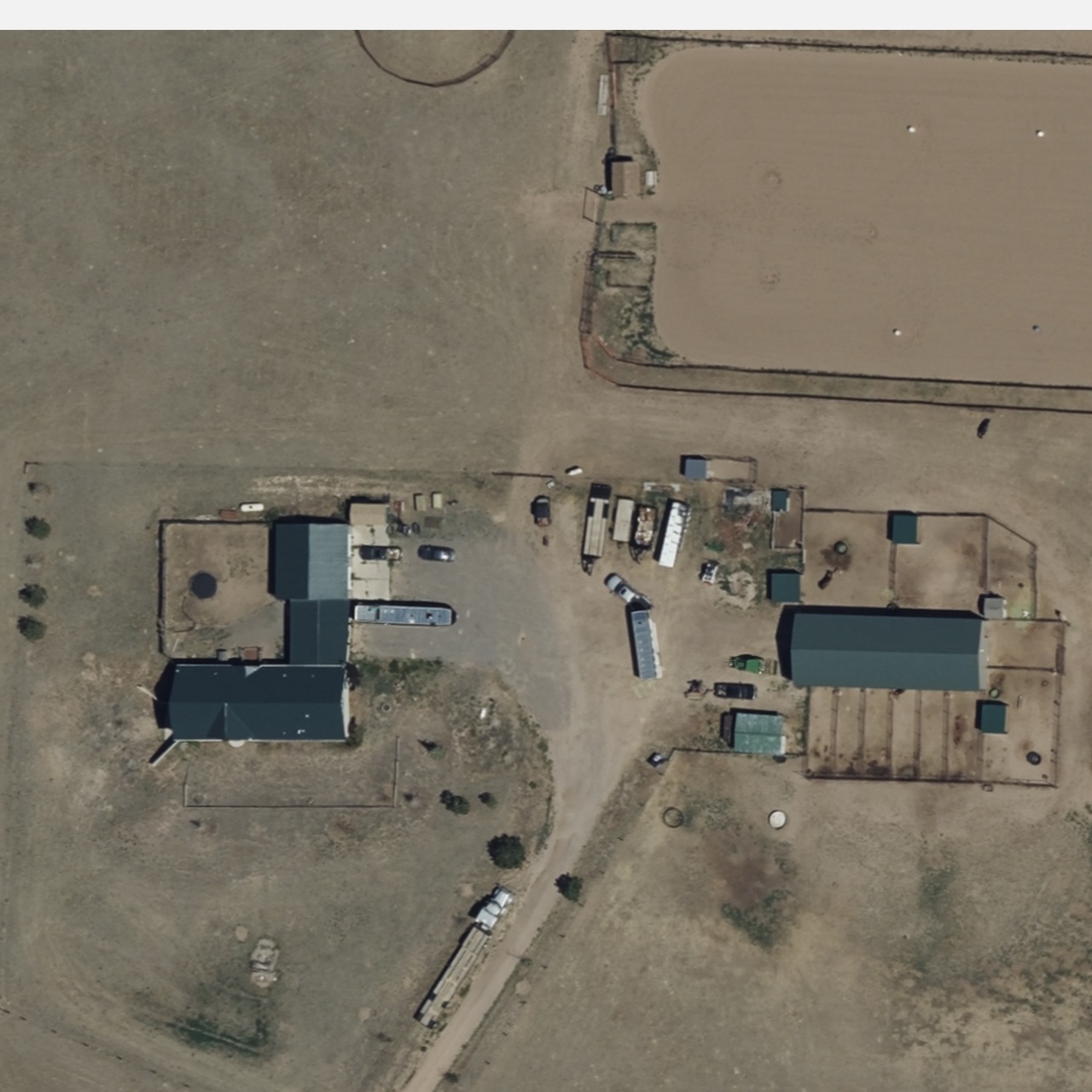 Overhead Norris property view showing the home, long barn, and multiple ranch structures